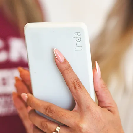 Woman holding a LINDA device