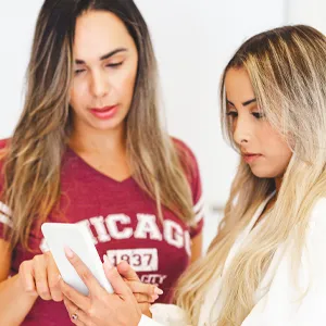 Two women looking at their LINDA results.
